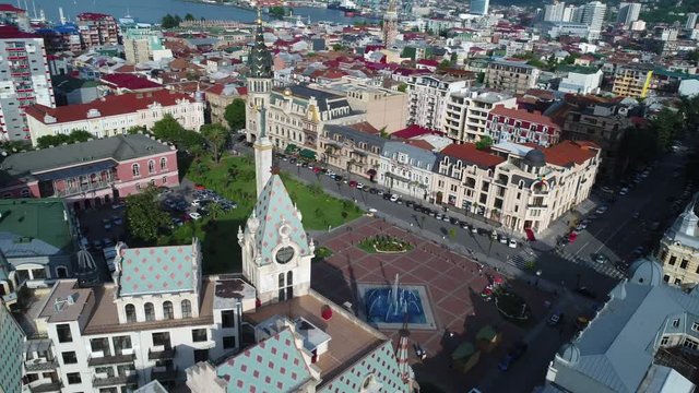 Aerial view of Europe square in Batumi downtown. Camera flying over beautiful old roofs and opened amazing city and sea view.