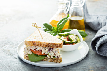 Chicken salad sandwich with spinach and tomato