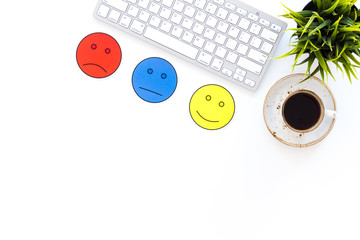 Customer satisfaction concept. Emoji smile, neutral, sad on work desk on white background top view copy space