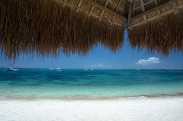 Fototapeta na wymiar Tropical Beach View From Native Style Vacation Cabana