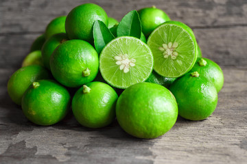 Limes on old wooden background