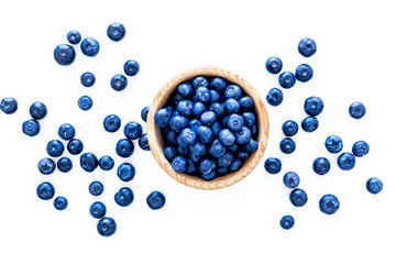 Fresh recently picked blueberries in bowl on white background top view copy space