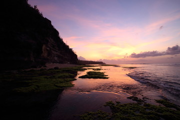Fototapeta na wymiar Magenta purple sunset colors reflected in tide pools
