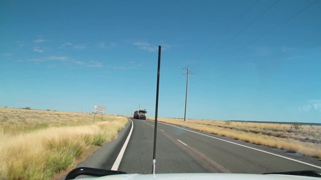 A medium shot of a long road and a 10 wheeler truck.