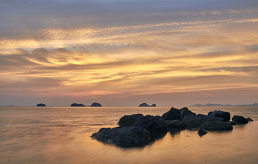 Fototapeta na wymiar Sea lagoon on a colourful sunset background 