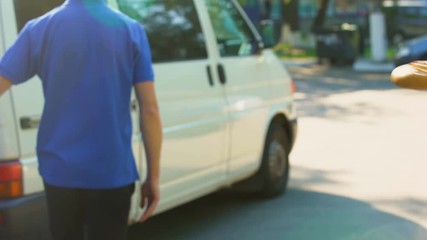Smiling woman receiving grocery bag from delivery worker, supermarket service