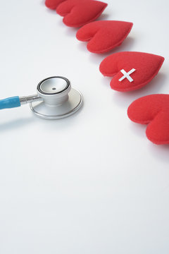 Red heart with stethoscope isolated on white backgroun