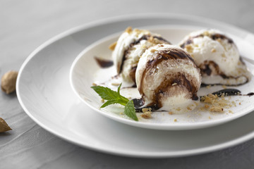 Vanilla Ice Cream with Mint in bowl and chocolate sauce