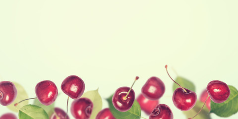 Summer berry cherry banner background. Collage of flying berries. Toned