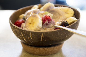 Blueberry smoothie bowl with banana, granola, strawberry