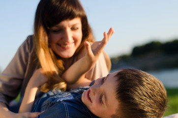 Obraz premium happy pregnant woman and she little sun