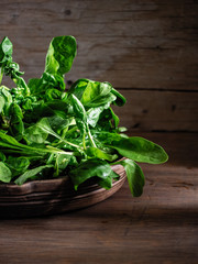 green fresh bunch of spinach in a beautiful cup on a wooden background