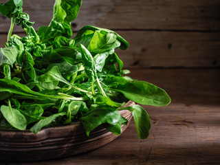 green fresh bunch of spinach in a beautiful cup on a wooden background