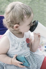 Toddler with phone and cup of coffee