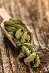Cardamom seasoning in a spoon on wooden table