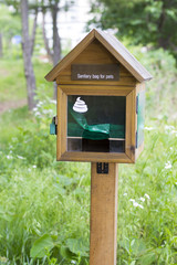 Wooden box with sanitary bags for collection excrement in Asian Park, South Korea