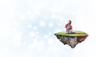 Concept of careless happy childhood with girl dreaming about som
