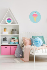 Ice cream poster on white wall above bed in scandi child's bedroom interior