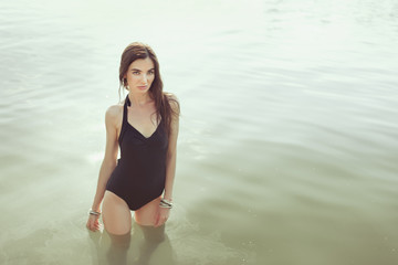 Beautiful woman standing in the water.