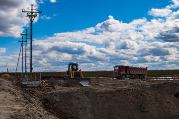 Fototapeta na wymiar the work of the bulldozer on the construction site
