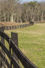 Fototapeta premium Wooden fence twisting beside the field
