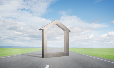 Conceptual background image of concrete home sign on asphalt road
