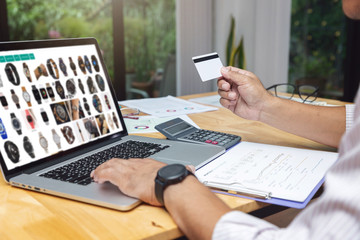 E-commerce concept, Businessman select item from website shoppping online and holding credit card