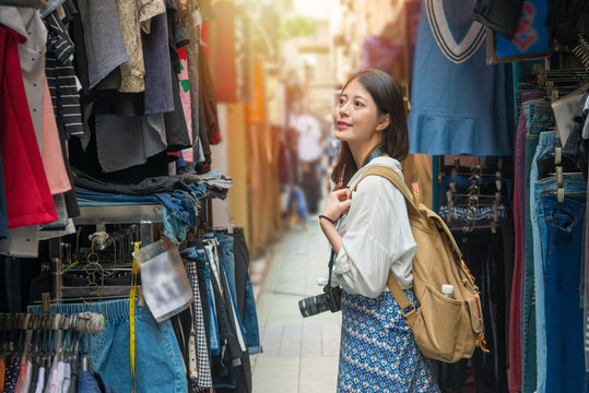 female tourist shopping in the street with camera