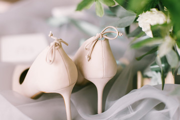 Wedding flowers and bridal shoes on tissue 