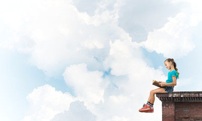Concept of careless happy childhood with girl exploring this world