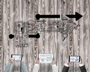 Top view of businesspeople sitting at table and using gadgets