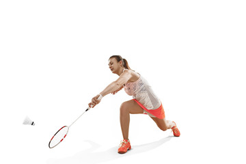 Obraz premium Young woman playing badminton over white background