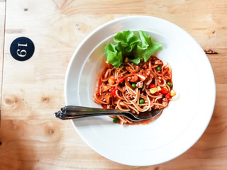 Spaghetti with tomato sauce, chicken in white cup in restaurant steak.