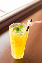 glass of lemonade. glass of orange juice. a glass with a straw. lemonade with mint