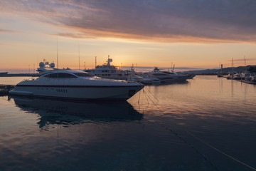Obraz na płótnie Canvas Luxury yachts docked in sea port at sunset, Sochi, Russia