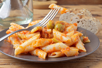 homemade stew of macaroni with tomato olive and pickle