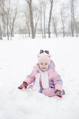 Happy loving caucasian family of mother father and daughter play, having fun in winter snowy park. Cute little girl playing