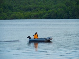 a man on a rubber boat rushes on the river