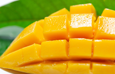 Fresh slice mango with green leaf background - 210125335