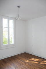 old empty room restored in white with a large window