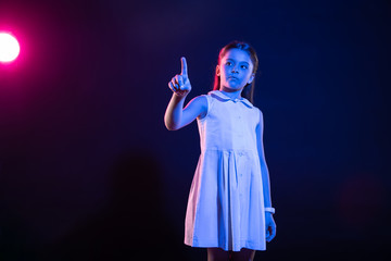 Using technologies. Determined dark-haired girl pressing an imaginary button and wearing a lovely dress