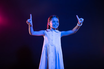 Fototapeta premium Happiness inside me. Exuberant dark-haired girl pressing imaginary buttons and wearing a lovely dress