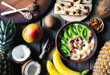 Yogurt with different fruits on a wooden background. Useful food, diet, organic.