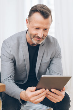Portrait of mature man using digital tablet