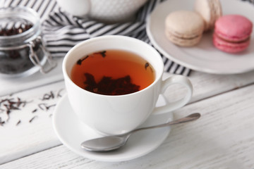 Cup of hot tea on white wooden table