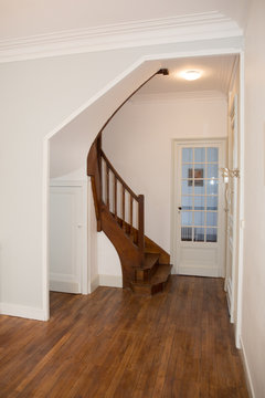 the entrance of the house with a beautiful old staircase