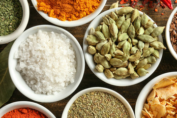 Bowls with various spices on table, closeup