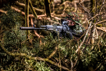 Airsoft player during patrol in forest