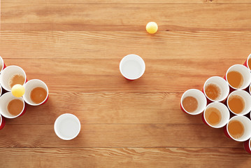 Cups and balls for beer pong on wooden table