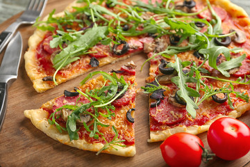 Tasty pizza on wooden board
